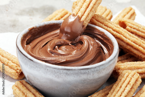 Traditional Spanish dessert churros with sugar and chocolate