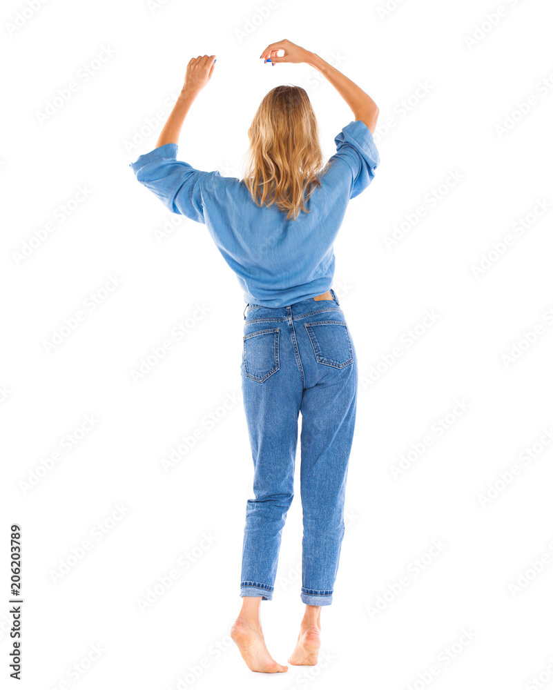 Young woman in blue jeans standing isolated on a white background Young woman in blue jeans standing isolated on a white background