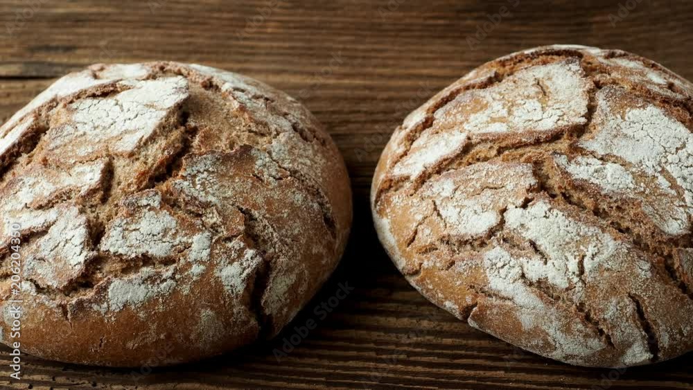 Delicious baked bread on a wooden background Delicious baked bread on a wooden background