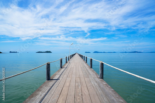 Landscape of wooden bridge in blue sea on tropical beach  and blue sky background .