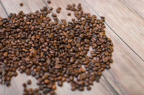 close up Coffee beans scattered on wood background