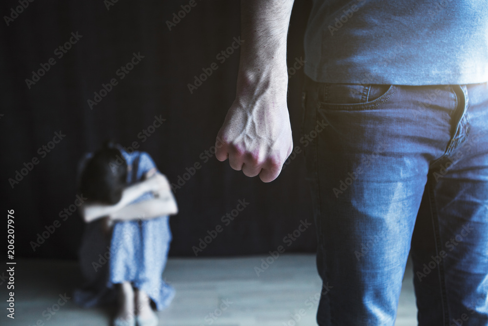 Scared woman protecting from mans aggression. Domestic violence concept Scared woman protecting from mans aggression. Domestic violence concept