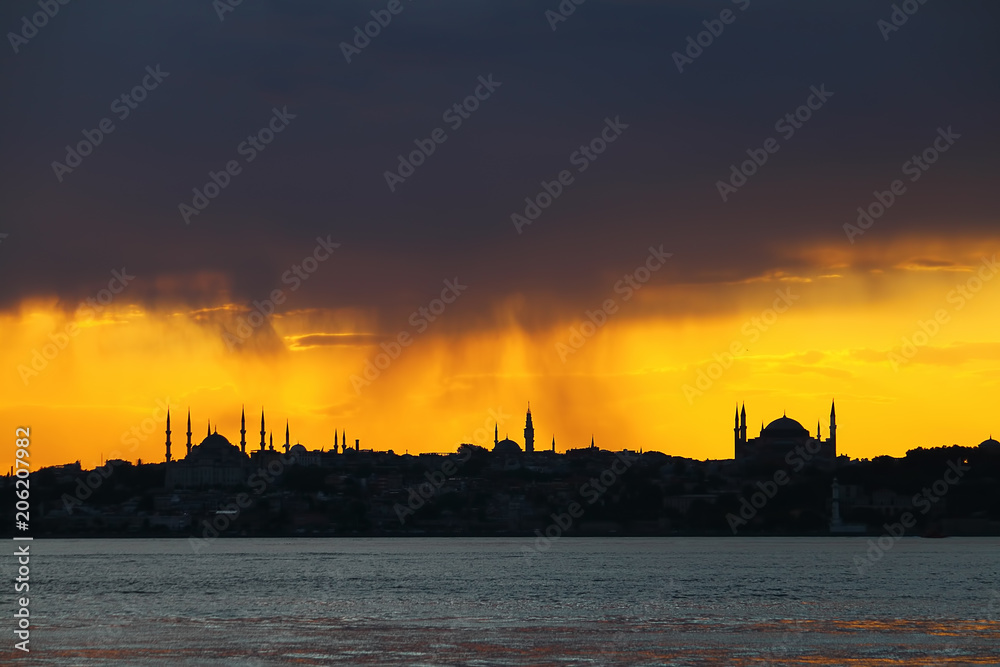 Naklejka premium Ramadan time with the muslim city istanbul silhouette