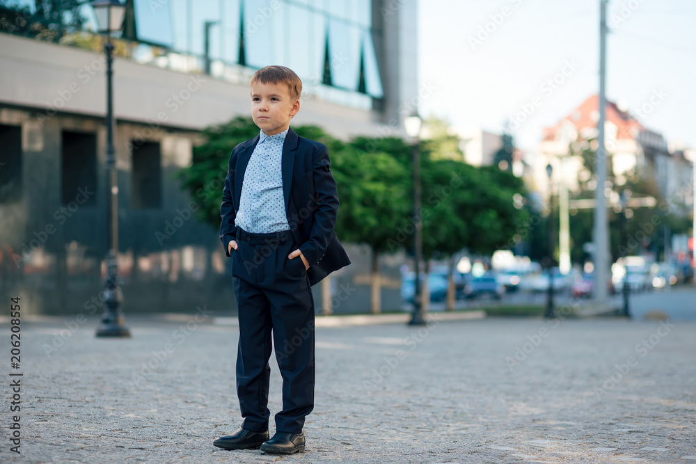 Boy in classic modern dark blue business suit