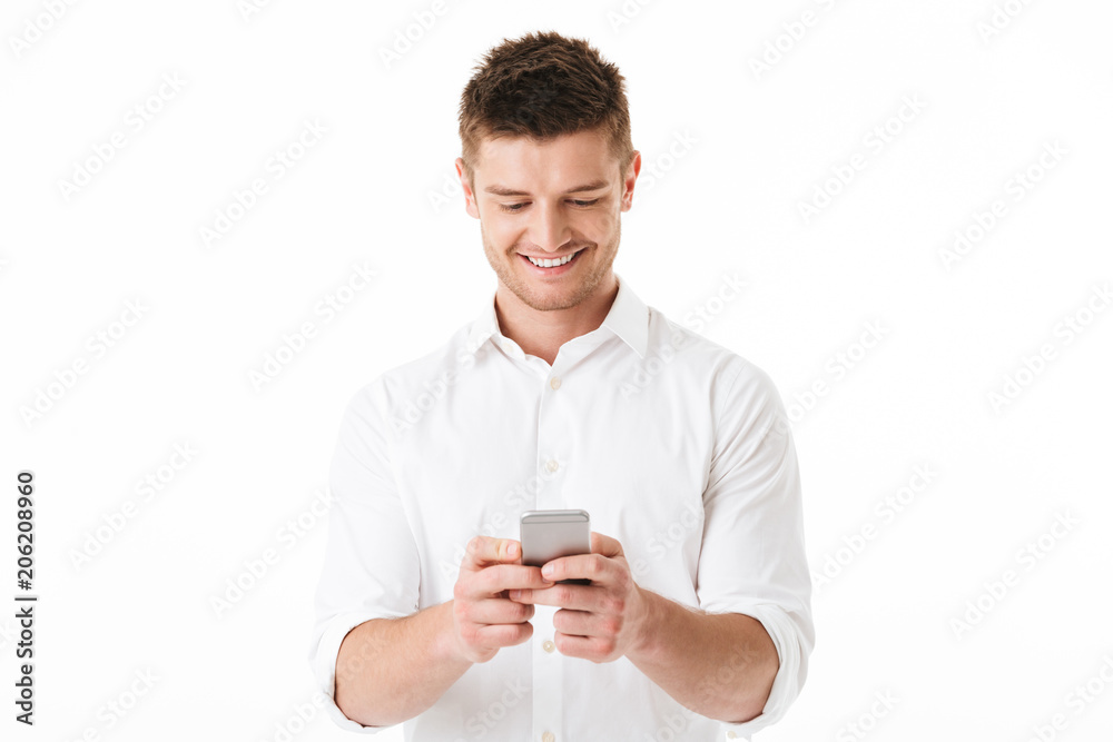 Portrait of a smiling young man using mobile phone Portrait of a smiling young man using mobile phone