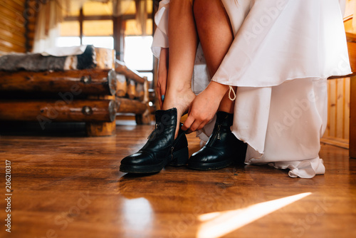 girl shoes on her feet while sitting on a chair