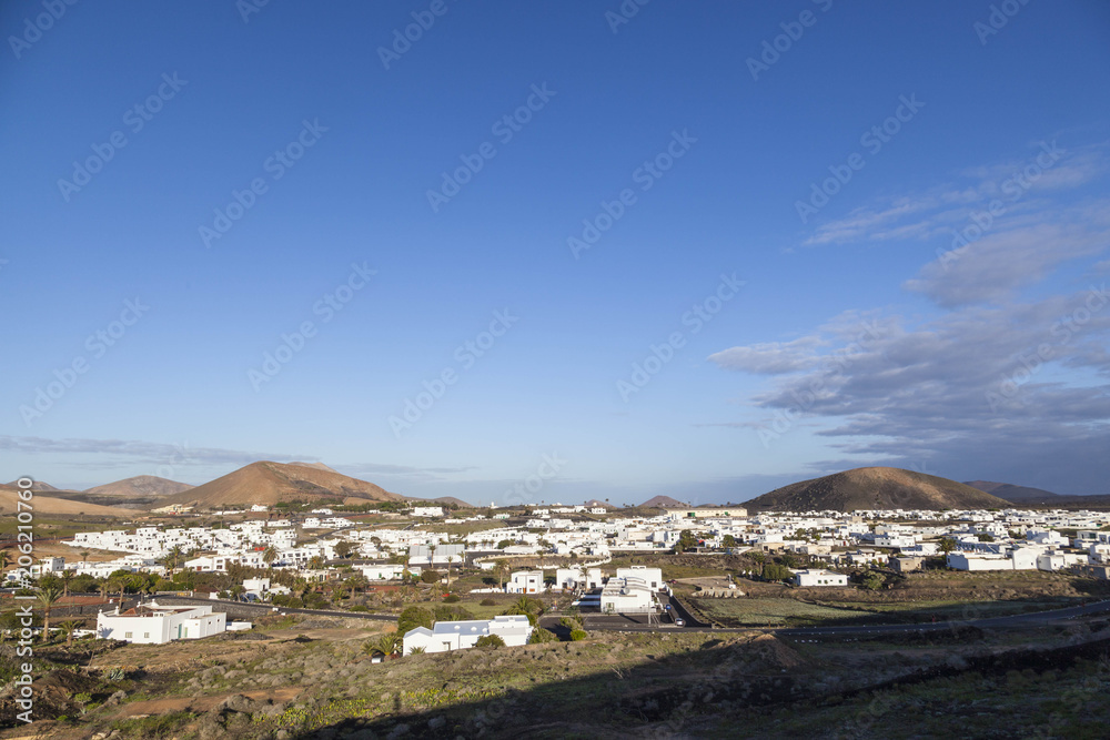 village of Uga in Lanzarote in morning fog and volcano
