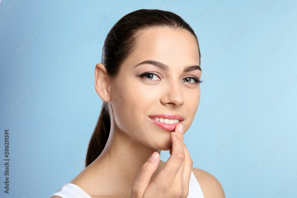 Young woman with sexy lips on color background Young woman with sexy lips on color background