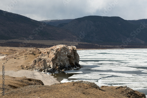 The white ice floes on the blue water. Lake Baikal in spring.
