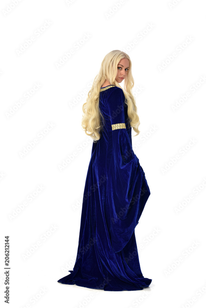 full length portrait of pretty blonde lady wearing  a blue fantasy medieval gown. standing pose on white background.