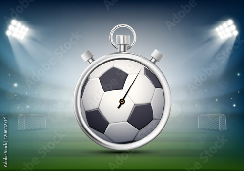 Sports stopwatch with a soccer ball on the stadium lawn