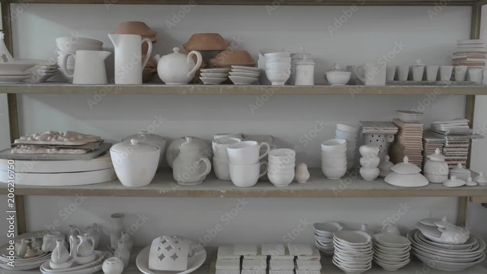Vertical pan of shelving full of raw pottery Vertical pan of shelving full of raw pottery
