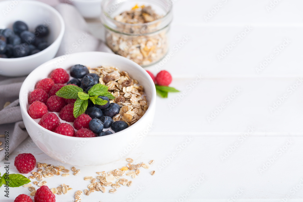 Smoothie bowl with yogurt, fresh aromatic berries and cereal. Close up view Smoothie bowl with yogurt, fresh aromatic berries and cereal. Close up view
