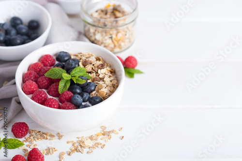 Smoothie bowl with yogurt  fresh aromatic berries and cereal. Close up view