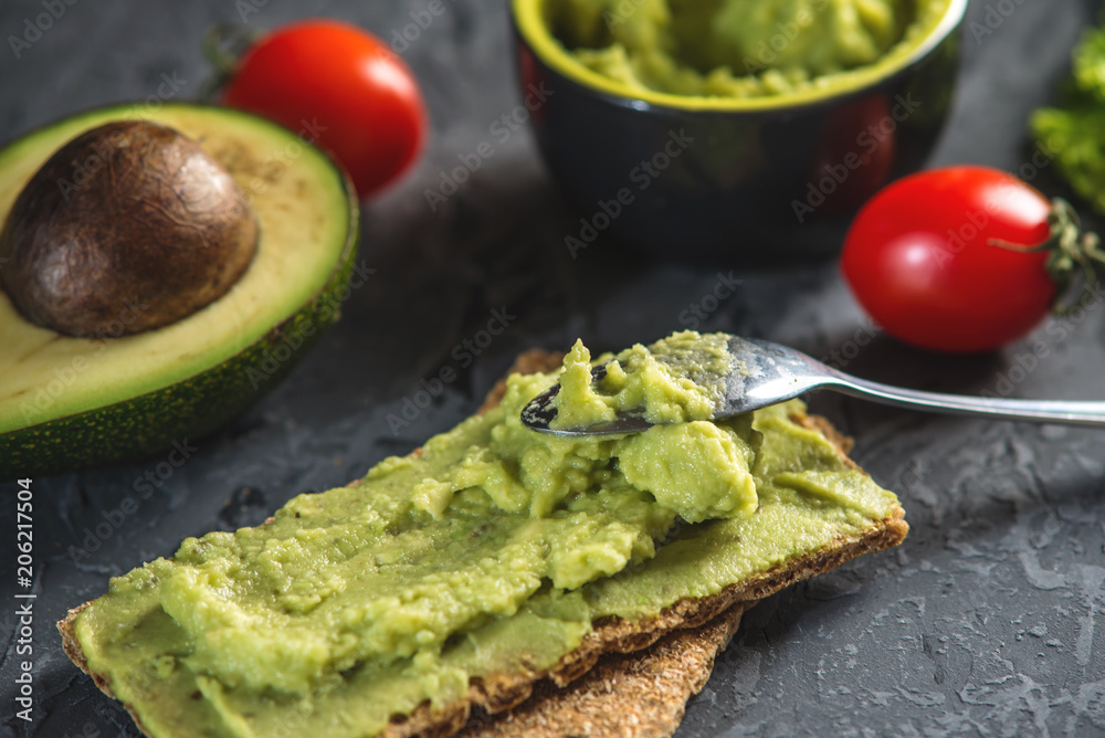 Mexican cold appetizer made of pureed avocado pulp with bread and vegetables. Concept healthy vegetarian Breakfast Mexican cold appetizer made of pureed avocado pulp with bread and vegetables. Concept healthy vegetarian Breakfast
