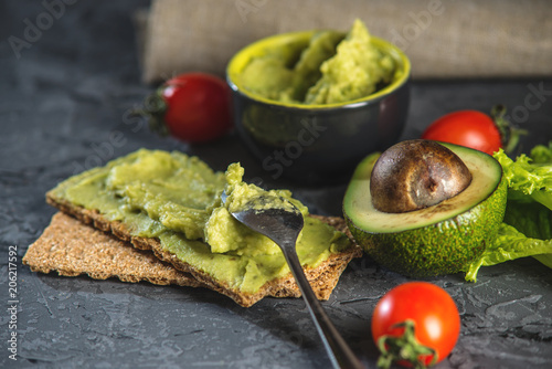 Mexican cold appetizer made of pureed avocado pulp with bread and vegetables. Concept healthy vegetarian Breakfast