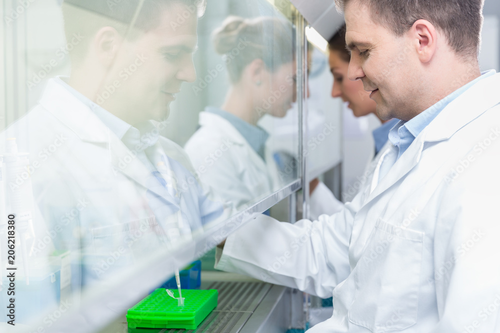 Researchers in science lab preparing samples for analysis Researchers in science lab preparing samples for analysis