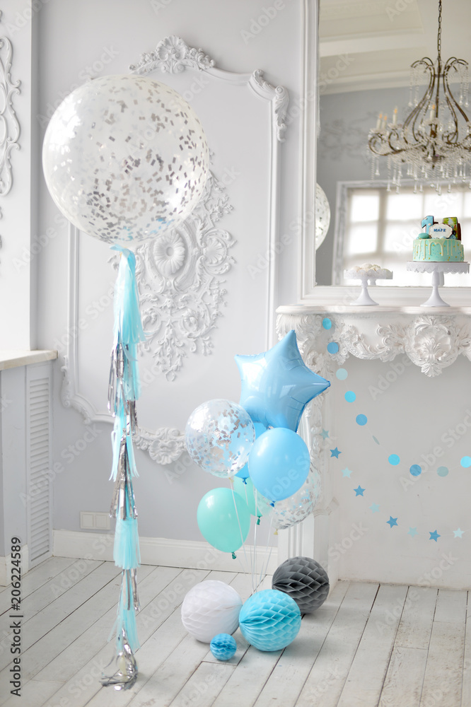 One year birthday decorations. A lot of balloons blue and white colors. Blue stars. Big Balloons. Cake for holiday party. One year birthday decorations. A lot of balloons blue and white colors. Blue stars. Big Balloons. Cake for holiday party.