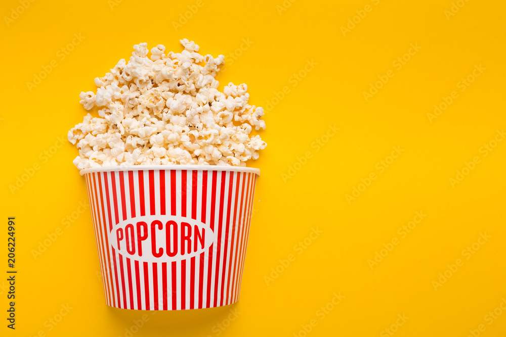 Bucket of popcorn on yellow background