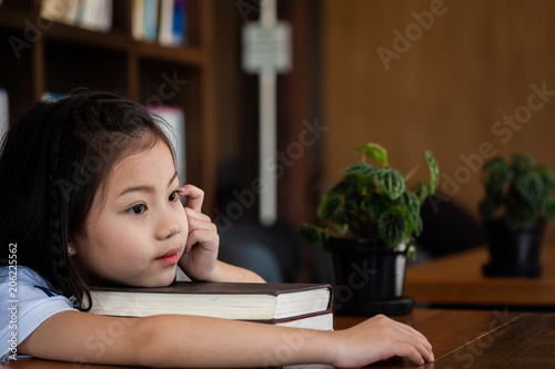 cute girl sitting in the room feeling tired and headache, children concept, education concept © I Believe I Can Fly