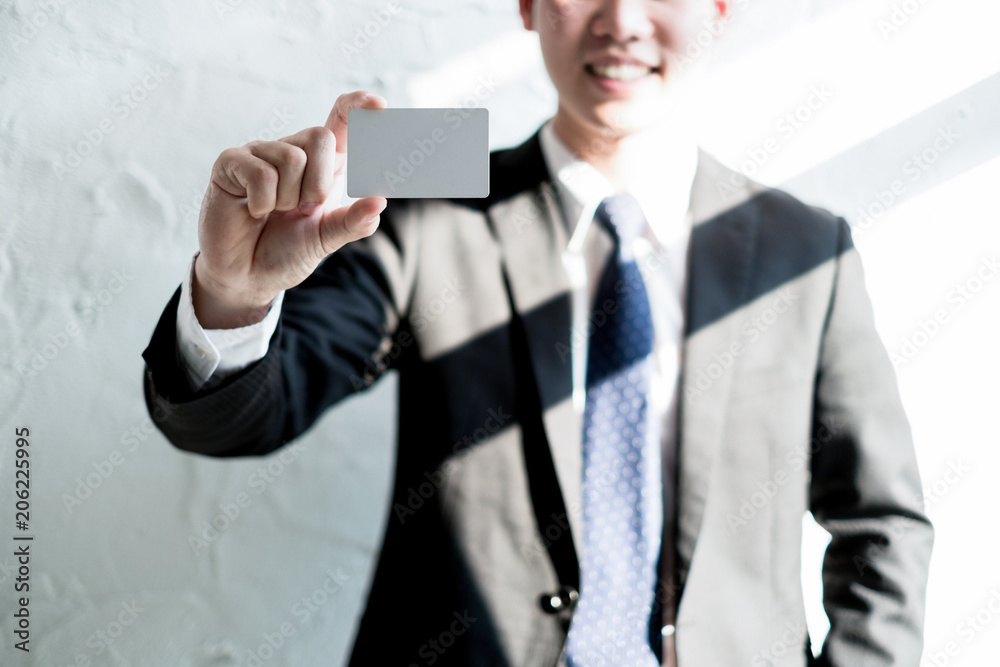 young businessman smile and holding blank business card in office, business concept young businessman smile and holding blank business card in office, business concept