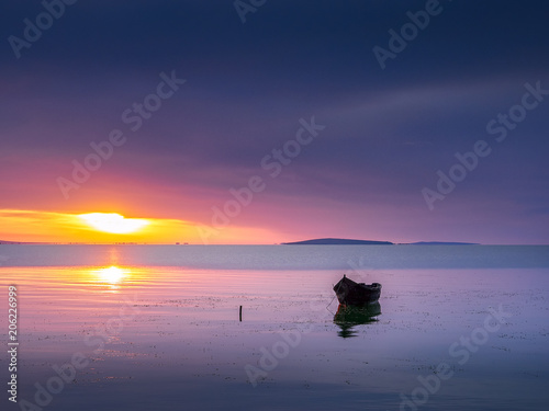 boat on water at sunrise