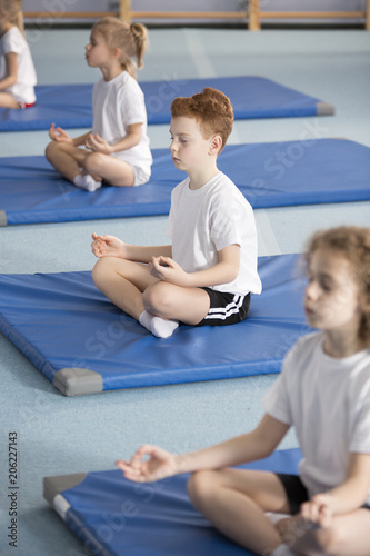 Children in relaxing meditation class
