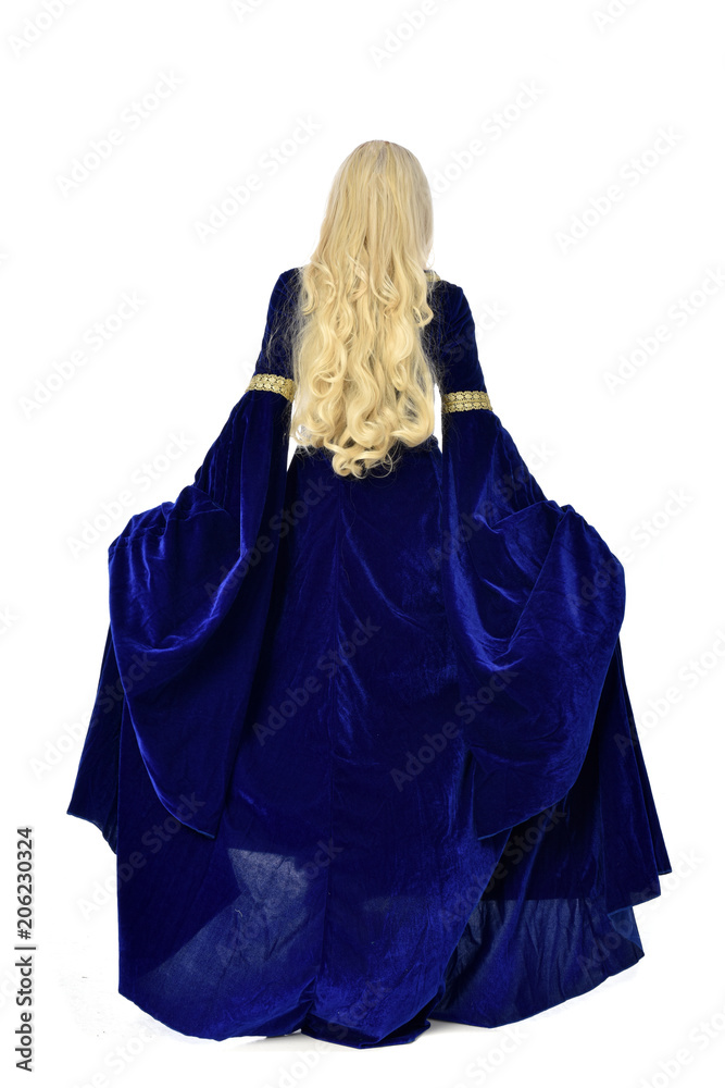 full length portrait of pretty blonde lady wearing a blue fantasy medieval gown. standing pose on white background. full length portrait of pretty blonde lady wearing a blue fantasy medieval gown. standing pose on white background.
