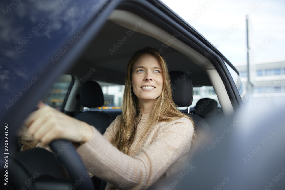 Portrait of smiling young woman sitting in car Portrait of smiling young woman sitting in car