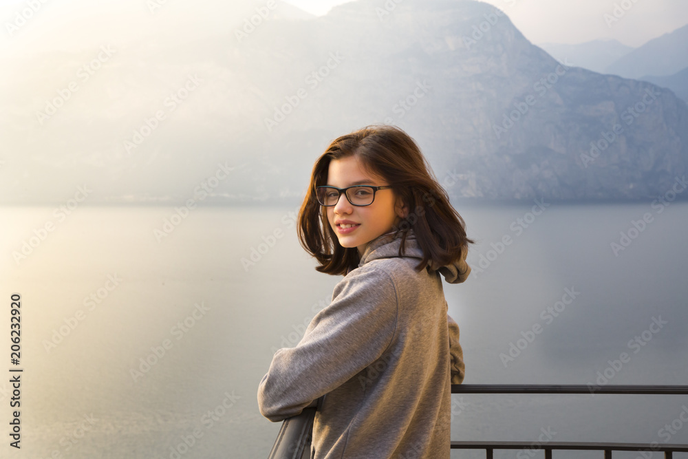 Italy, Brenzone, portrait of smiling girl on balcony Italy, Brenzone, portrait of smiling girl on balcony
