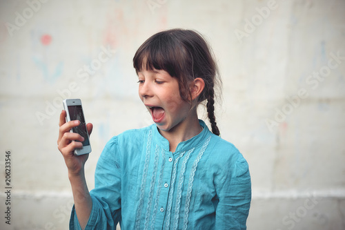 Broken glass screen smartphone in hand of upset girl, white background.