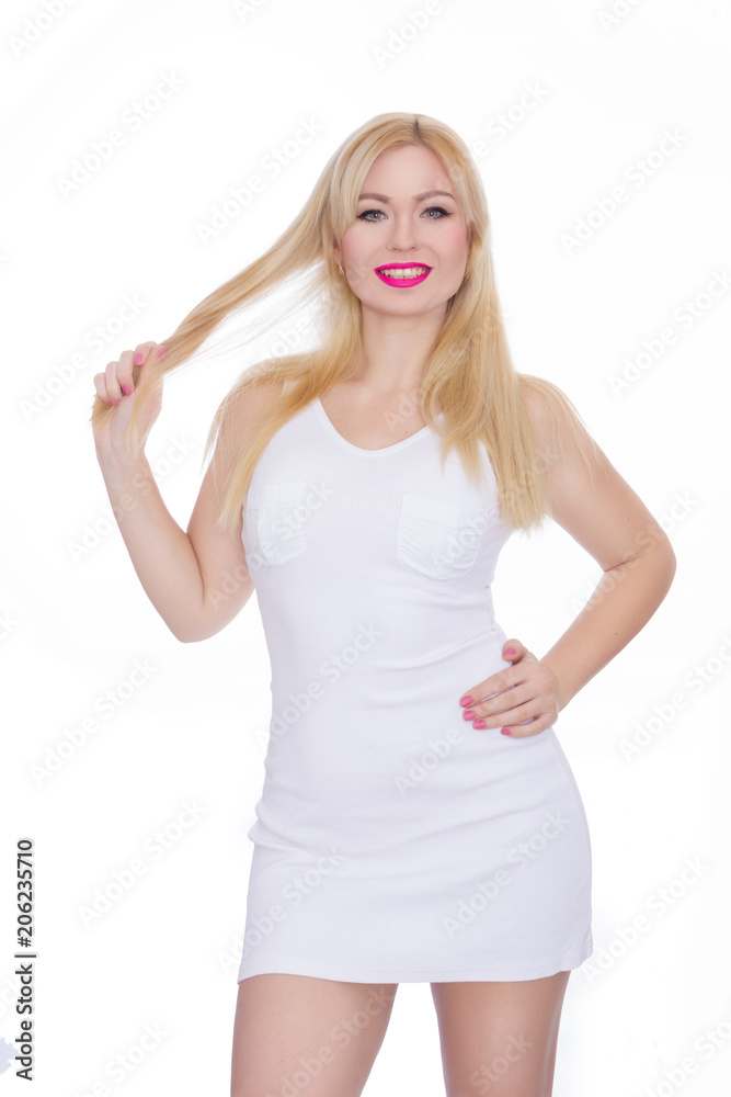 Portrait of a beautiful young blond woman with long hair in a summer white sarafan. Girl posing on white background in studio. Bright makeup with pink lips Portrait of a beautiful young blond woman with long hair in a summer white sarafan. Girl posing on white background in studio. Bright makeup with pink lips