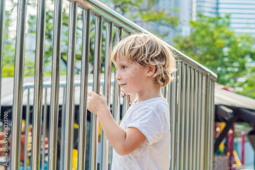 Funny cute happy baby playing on the playground. The emotion of happiness, fun, joy photo