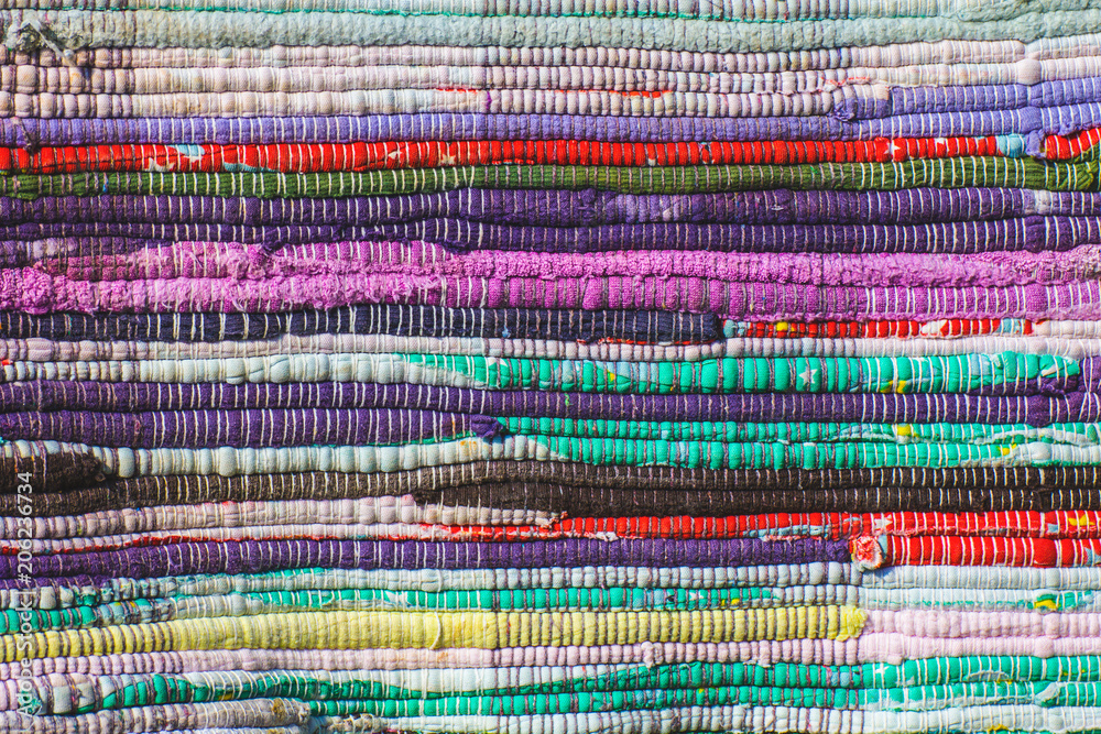 closeup of a colored homespun carpet background closeup of a colored homespun carpet background