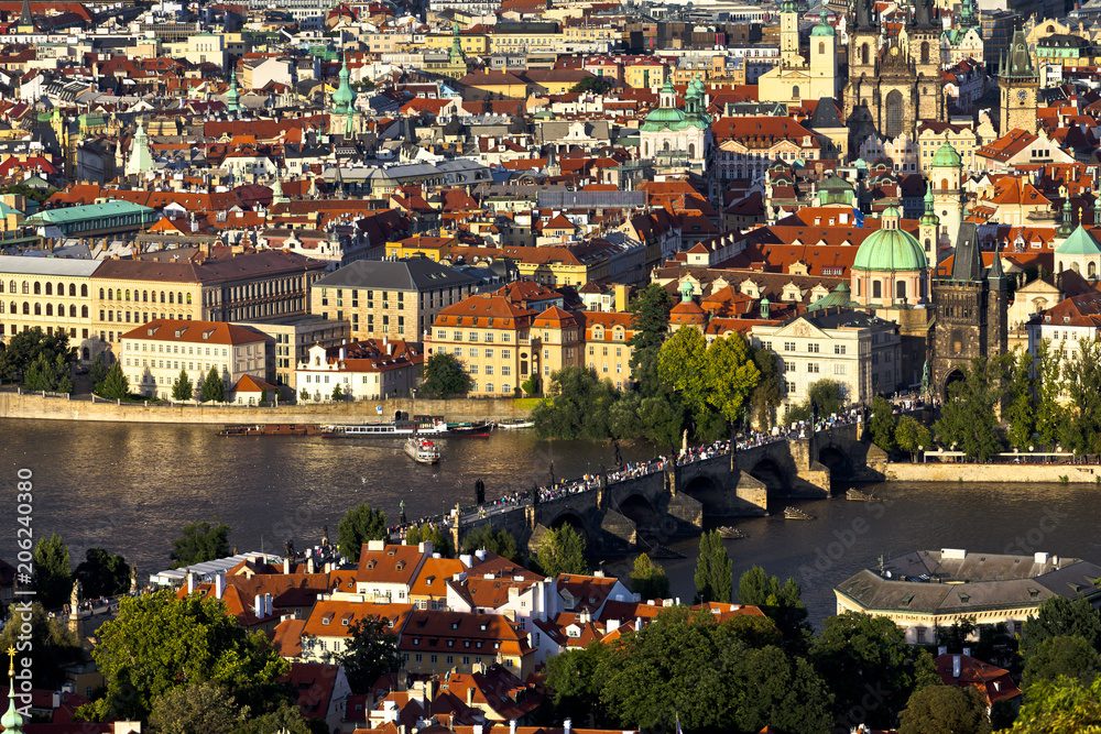 View of the Charles Bridge and the Old Town district in Prague, Czech Republic at sunset.