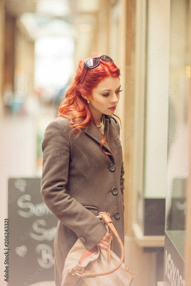 Fototapeta premium Beautiful young woman shopping in the city, mall with shopping bag, happy shopping tour