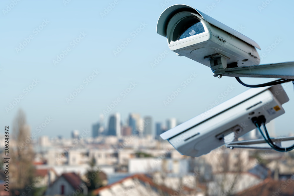 security CCTV camera monitoring system with panoramic view of a city on blurry background security CCTV camera monitoring system with panoramic view of a city on blurry background
