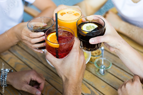 Photography Closeup of friends toasting glasses