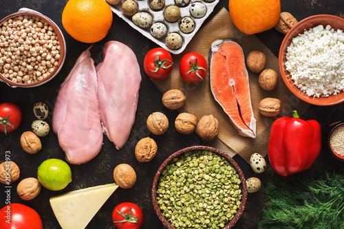 Balanced dietary products. The concept of healthy eating. Background of a healthy meal. Fruits, vegetables, salmon, chicken fillet, cereals. The view from above, flat lay.