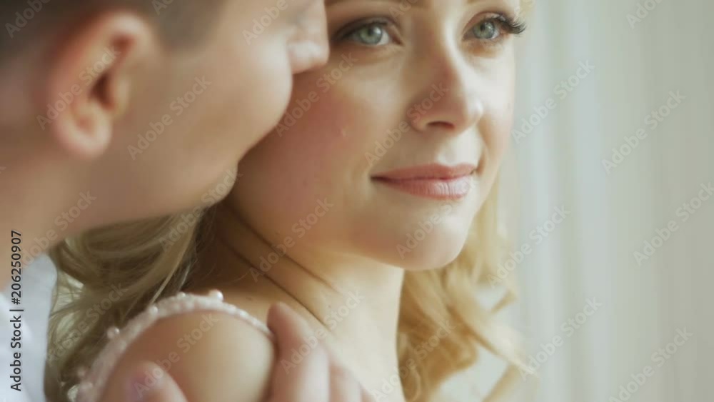 guy kisses his beloved pregnant woman standing at the window guy kisses his beloved pregnant woman standing at the window