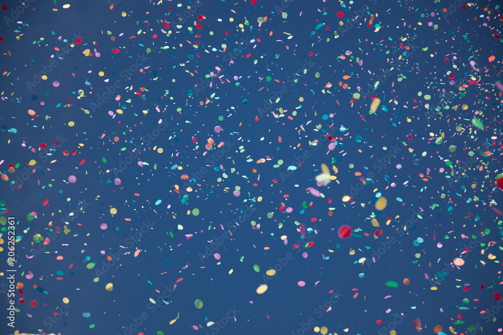 confetti falling during a festival or carnival in the city - obrazy, fototapety, plakaty 