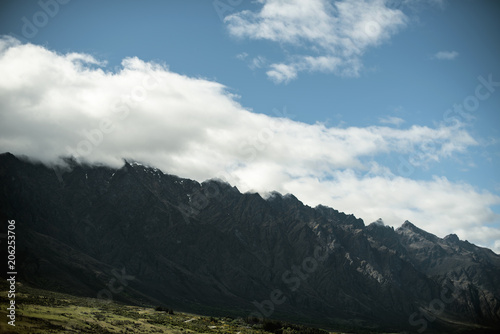 Landscape of shady mountains with huge clouds over them. day shot with blue sky. © josemanuelerre