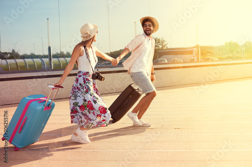 Happy couple arrived at the holiday destination photo