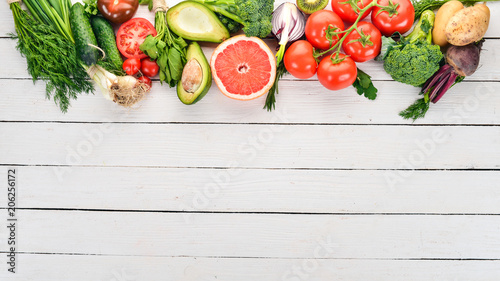 Fototapeta Naklejka Na Ścianę i Meble -  Healthy food. Vegetables and fruits. On a white wooden background. Top view. Copy space.
