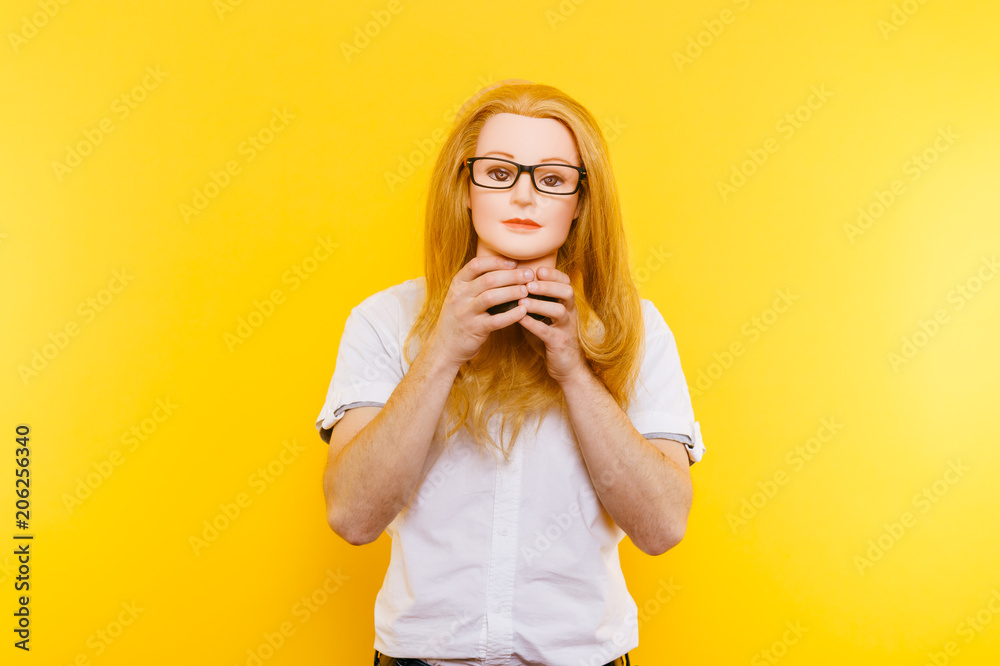 Excited bizarre strange odd couple have fun with plastic mannequin. Weird relationship. Happy adult bald man in orange glasses isolated on yellow background. Oddball rebel with hairy girl head. Excited bizarre strange odd couple have fun with plastic mannequin. Weird relationship. Happy adult bald man in orange glasses isolated on yellow background. Oddball rebel with hairy girl head.