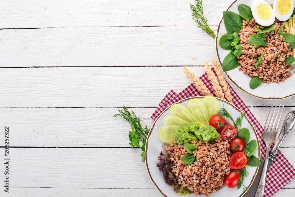 Buckwheat with vegetables. On a wooden background. Top view. Copy space. Buckwheat with vegetables. On a wooden background. Top view. Copy space.