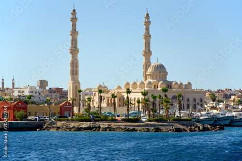Seascape with a mosque on the shore of the harbor in the Arab city. Hurghada, Egypt photo