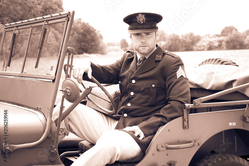 Εκτύπωση καμβά Handsome American WWII GI Army officer in uniform riding Willy Jeep