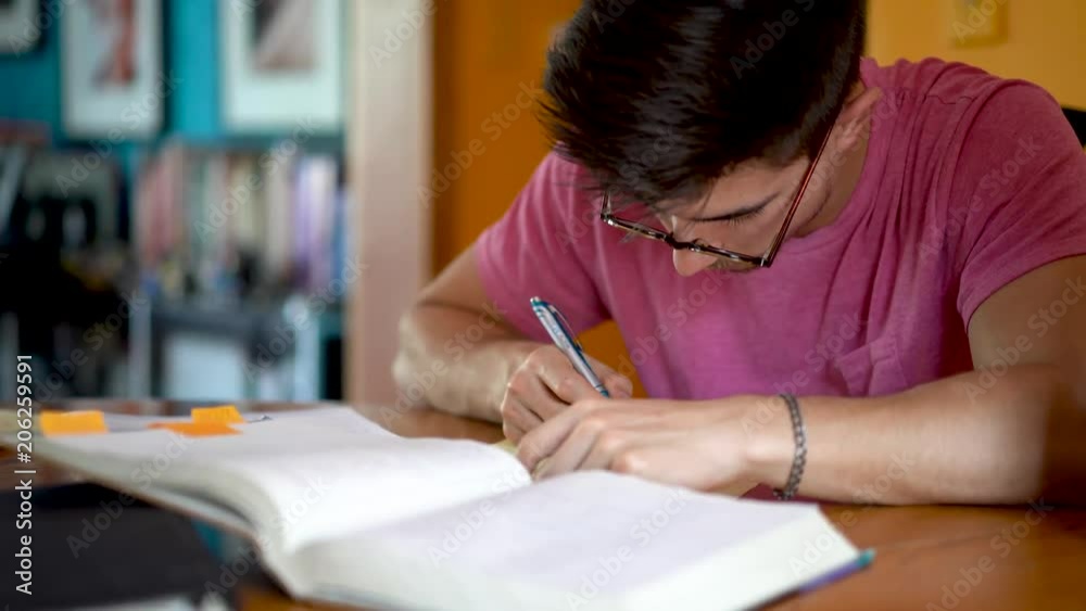 Closeup of teenage son working on math homework. Closeup of teenage son working on math homework.