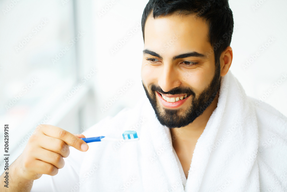 Beautiful Smiling Man Brushing Healthy White Teeth With Brush. High Resolution Image Beautiful Smiling Man Brushing Healthy White Teeth With Brush. High Resolution Image